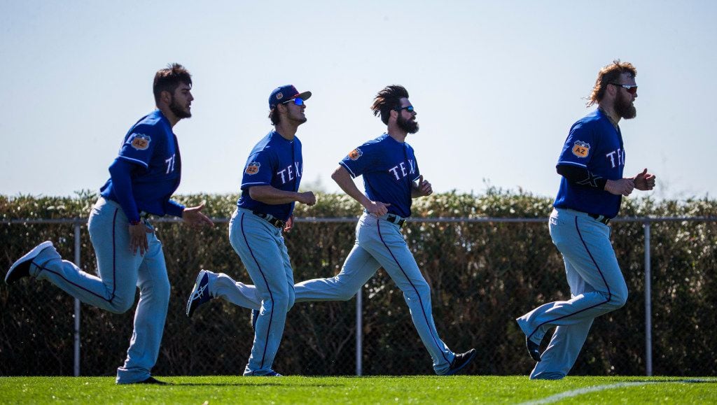 Texas Rangers starting pitcher Martin Perez (33), starting pitcher Yu Darvish (11), starting pitcher Cole Hamels (35) and starting pitcher Andrew Cashner (54) run during a spring training workout at the team's training facility on Tuesday, February 15, 2017 in Surprise, Arizona. (Ashley Landis/The Dallas Morning News)
