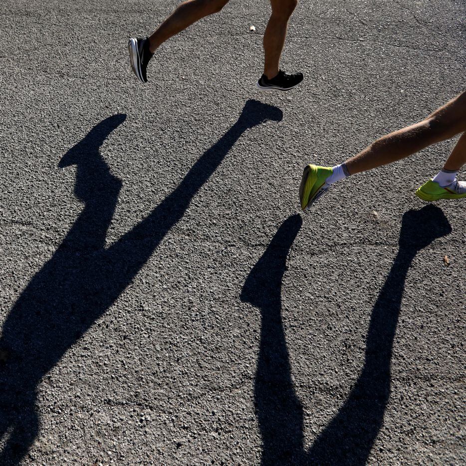 Runners approach the 16 mile marker during the BMW Dallas Marathon at White Rock Lake in...