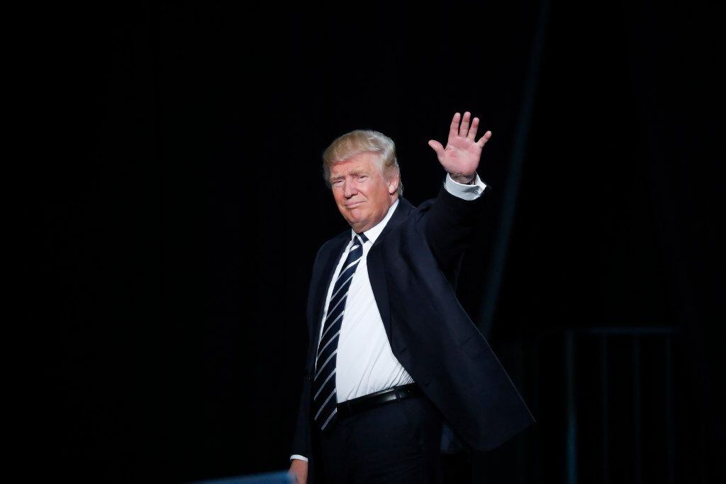 Republican presidential candidate Donald Trump waves to the audience exiting a campaign...