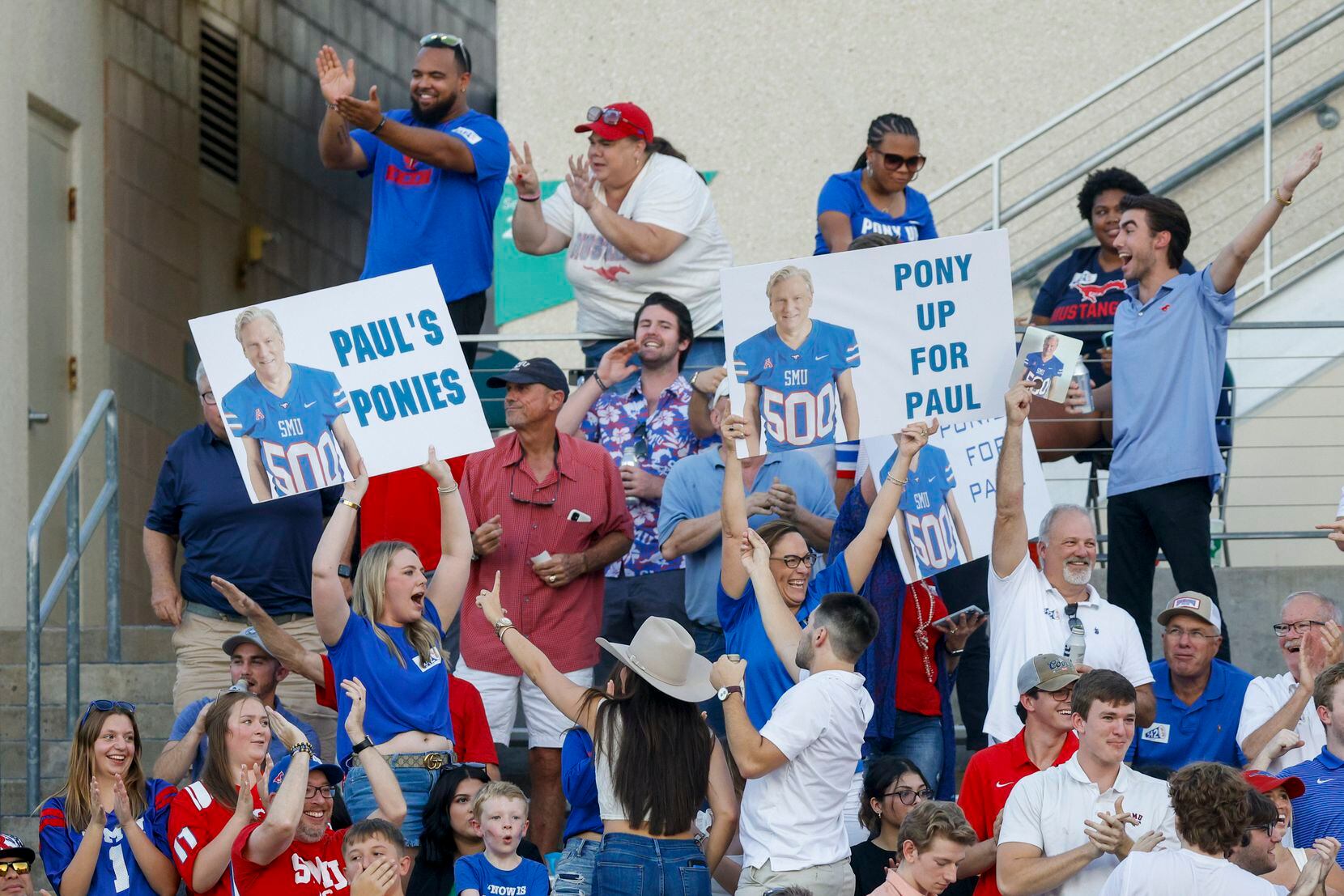 SMU fans raise signs for SMU alumnus and super fan Paul Layne as they celebrate a touchdown...