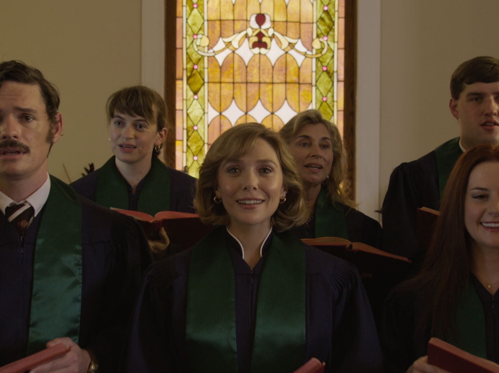 Elizabeth Olsen as Candy Montgomery sings in the church choir in a scene from HBO Max's...