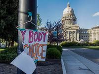 FILE - A sign reading "My body, my Choice," is taped to a hanger taped to a streetlight in...