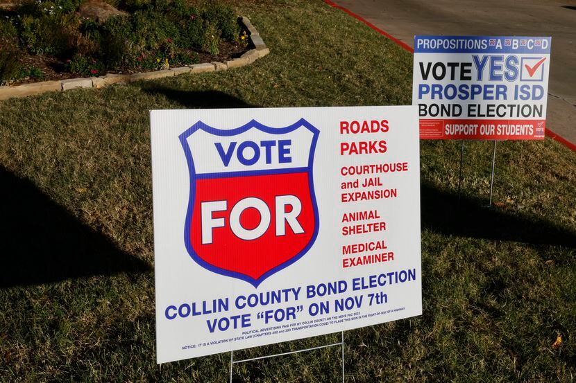 Signs are seen at Collin College McKinney Campus, where voters cast their ballots, Tuesday,...