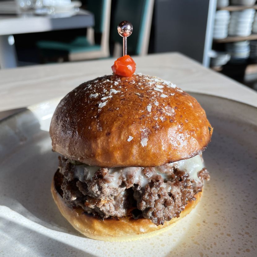 The X-Tudo burger on Meridian's new happy hour menu is a standout dish.