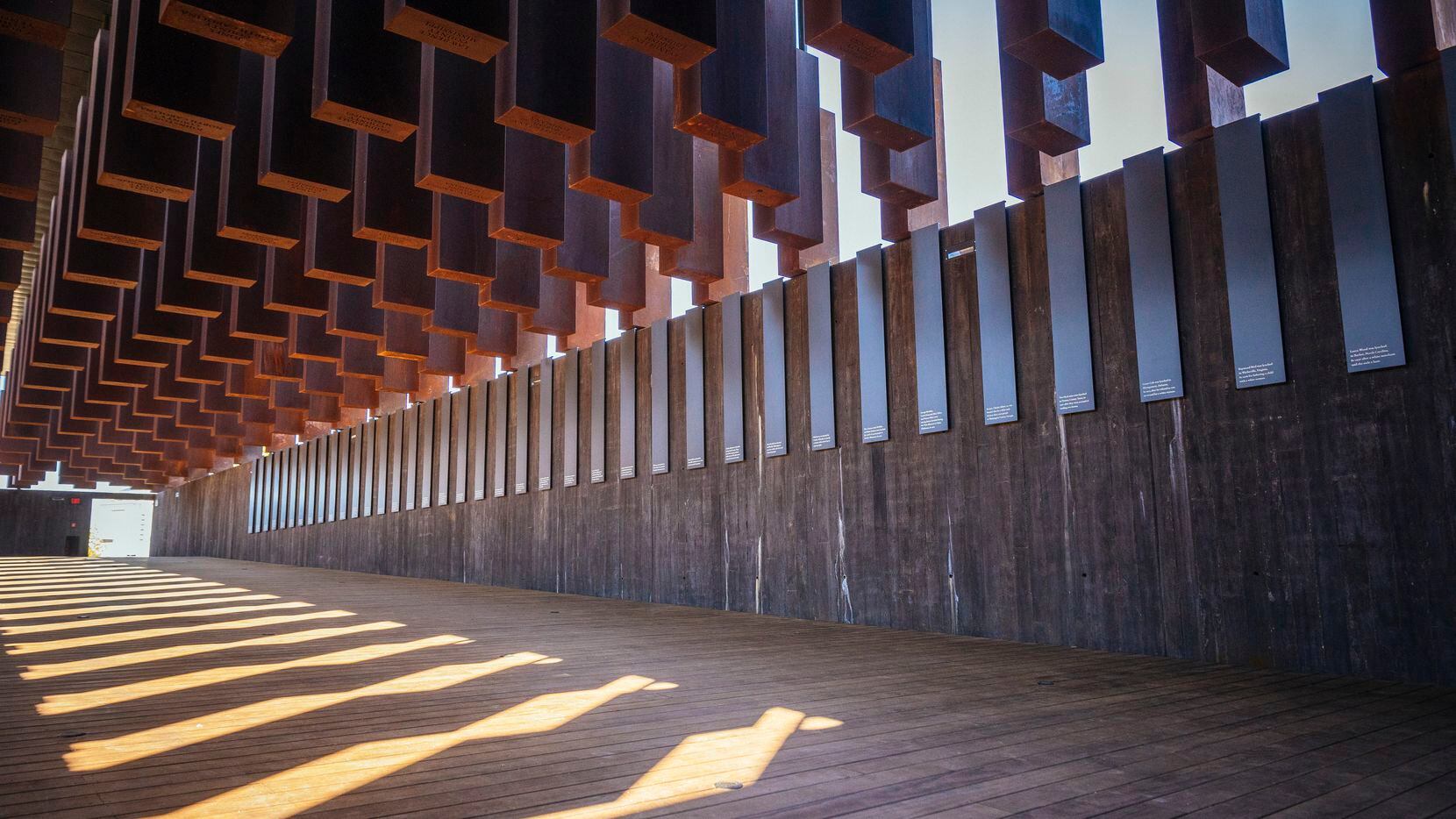 Eight hundred weathered steel columns, each one etched with the names of a lynching victim,...