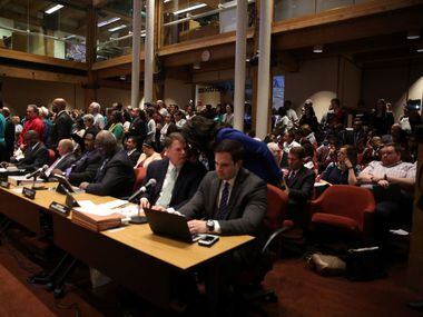 People pack into a meeting at the Dallas County Commissioners Court in Dallas on Tuesday,...