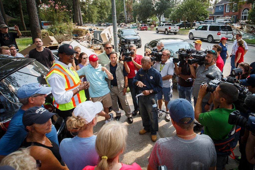 Houston Mayor Sylvester Turner talked with residents on a street of homes damaged by...