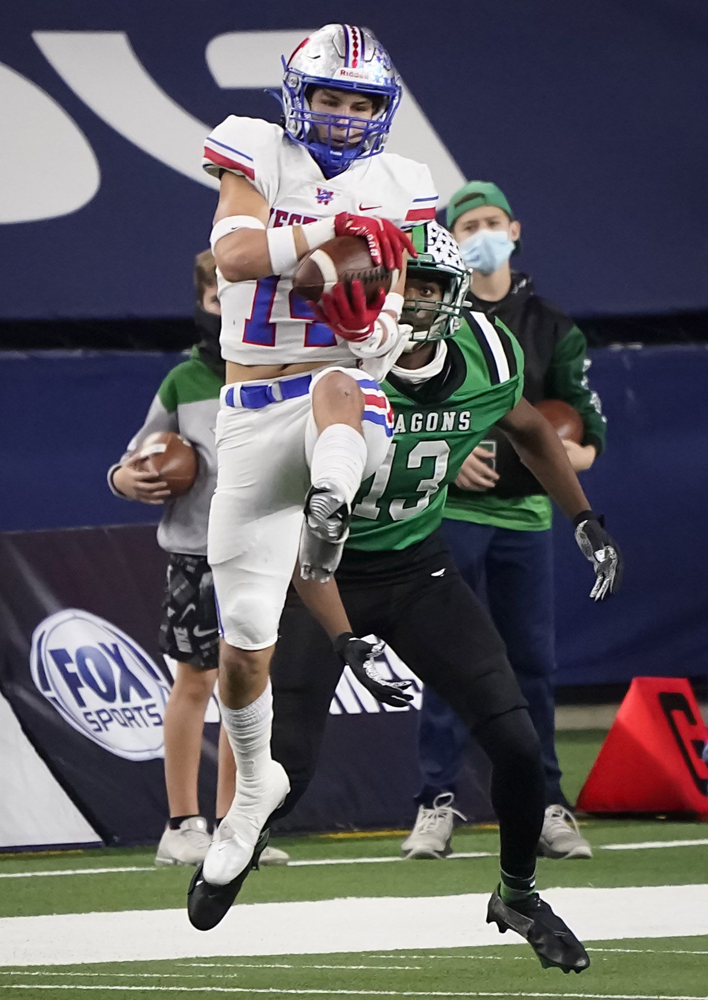 Austin Westlake defensive back Michael Taaffe (14) intercepts a pass intended for Southlake Carroll tight end RJ Maryland (13) during the second quarter of the Class 6A Division I state football championship game at AT&T Stadium on Saturday, Jan. 16, 2021, in Arlington, Texas.