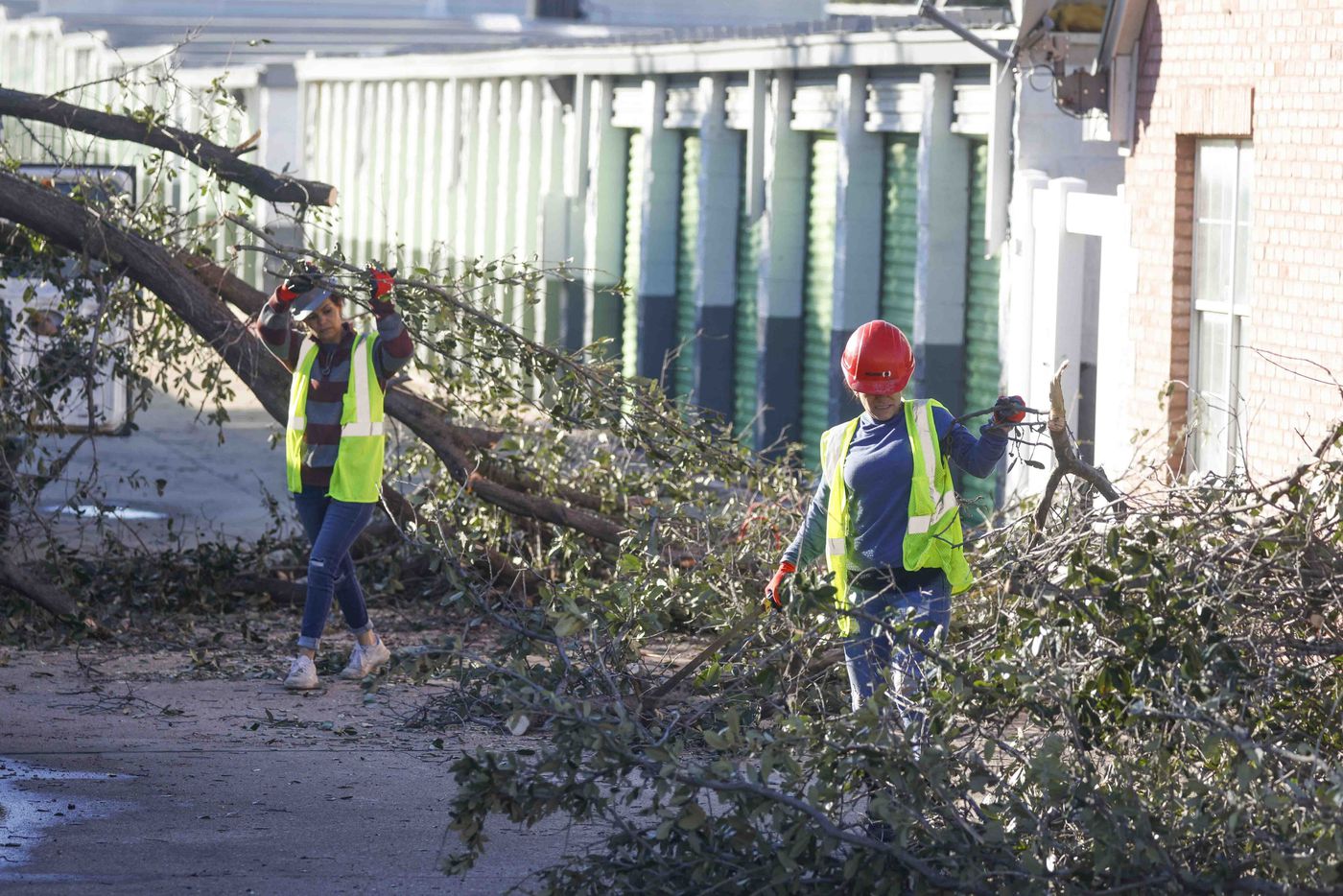 Crews work as they clean debris collected at Extra Space Storage in Grapevine on Wednesday,...