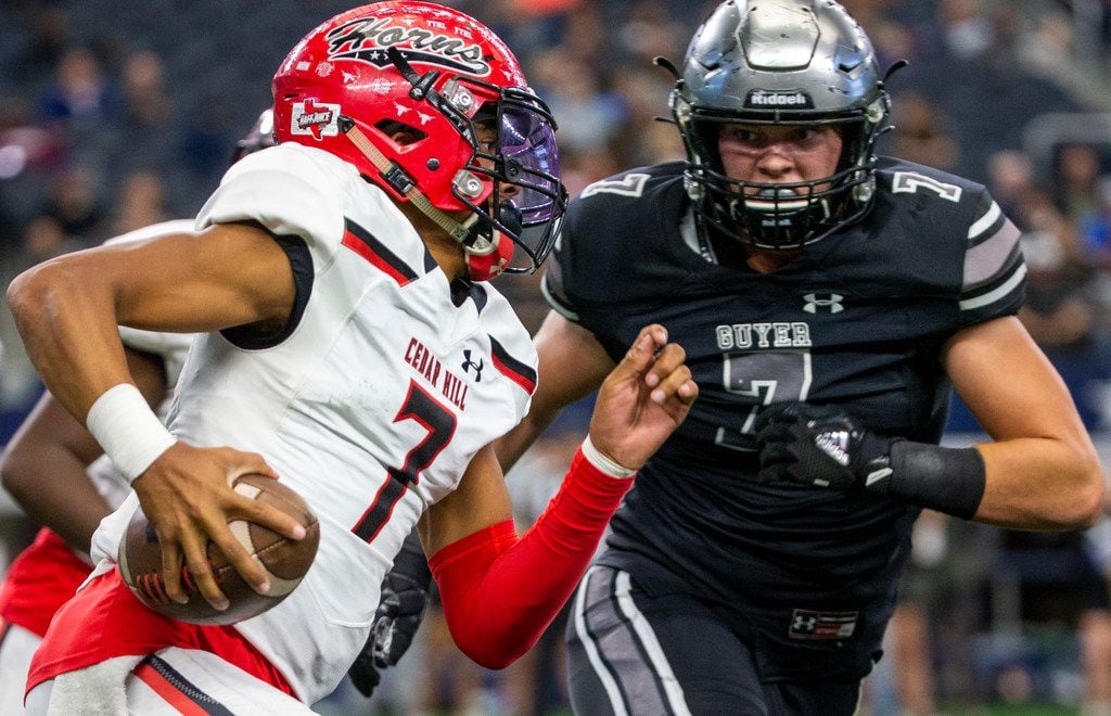 Cedar Hill quarterback Kaidon Salter (left, 7) tries to run the ball past Denton Guyer defensive lineman Cooper Lanz (7) during the Class 6A Division II area-round high school football playoff game at the AT&T Stadium in Arlington, Texas, on Saturday, November 23, 2019. 