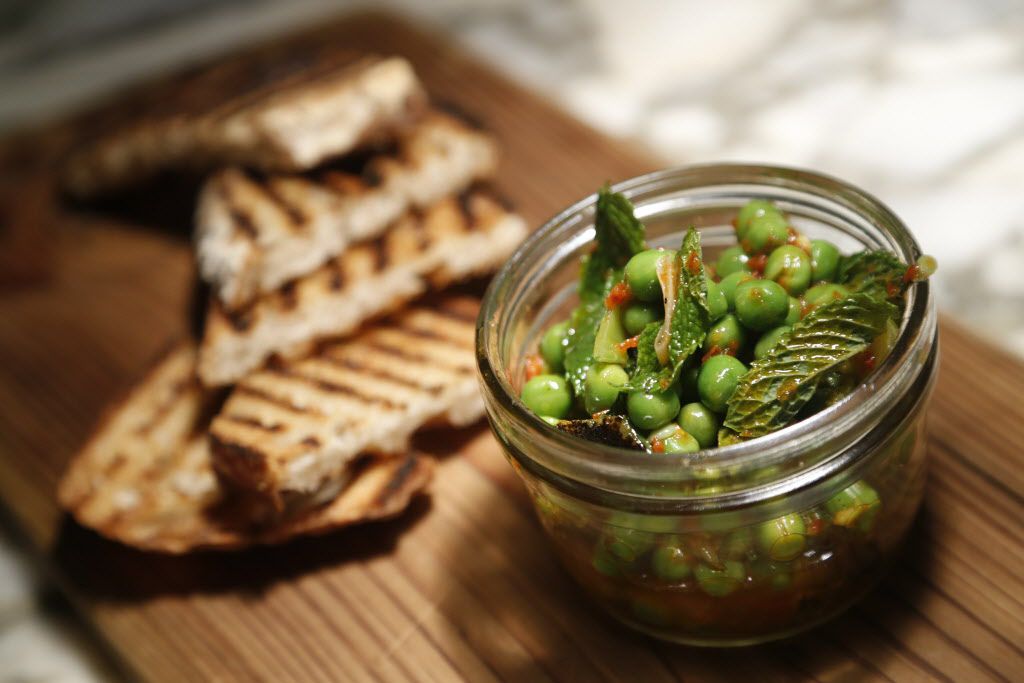 Spicy oil-cured peas at CBD Provisions in the Joule Hotel is served with house-made...
