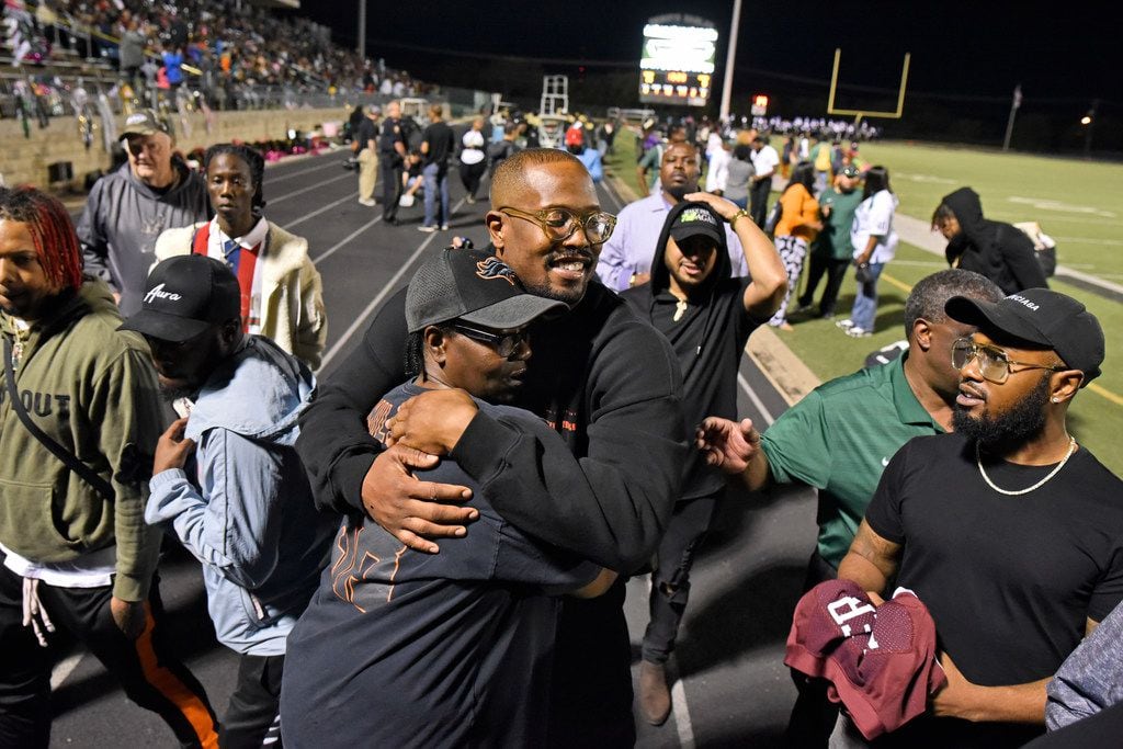 Denver Broncos linebacker and former DeSoto High School player, Von Miller, receives a hug...