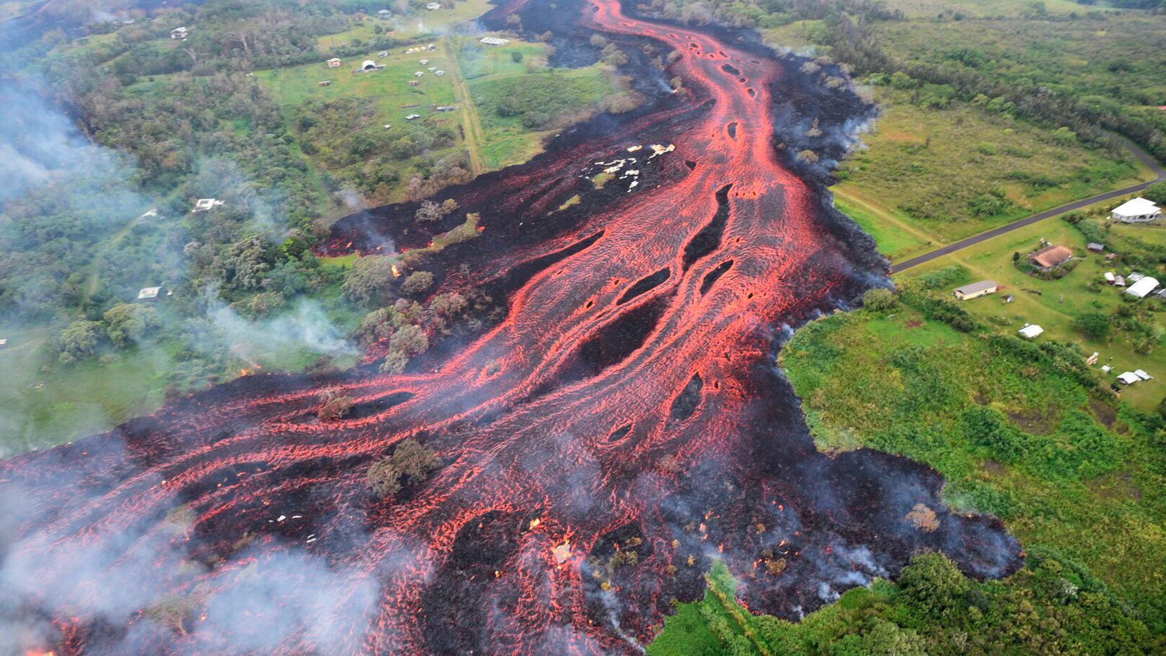 In this Saturday, May 19, photo released by the U.S. Geological Survey, lava flows from...