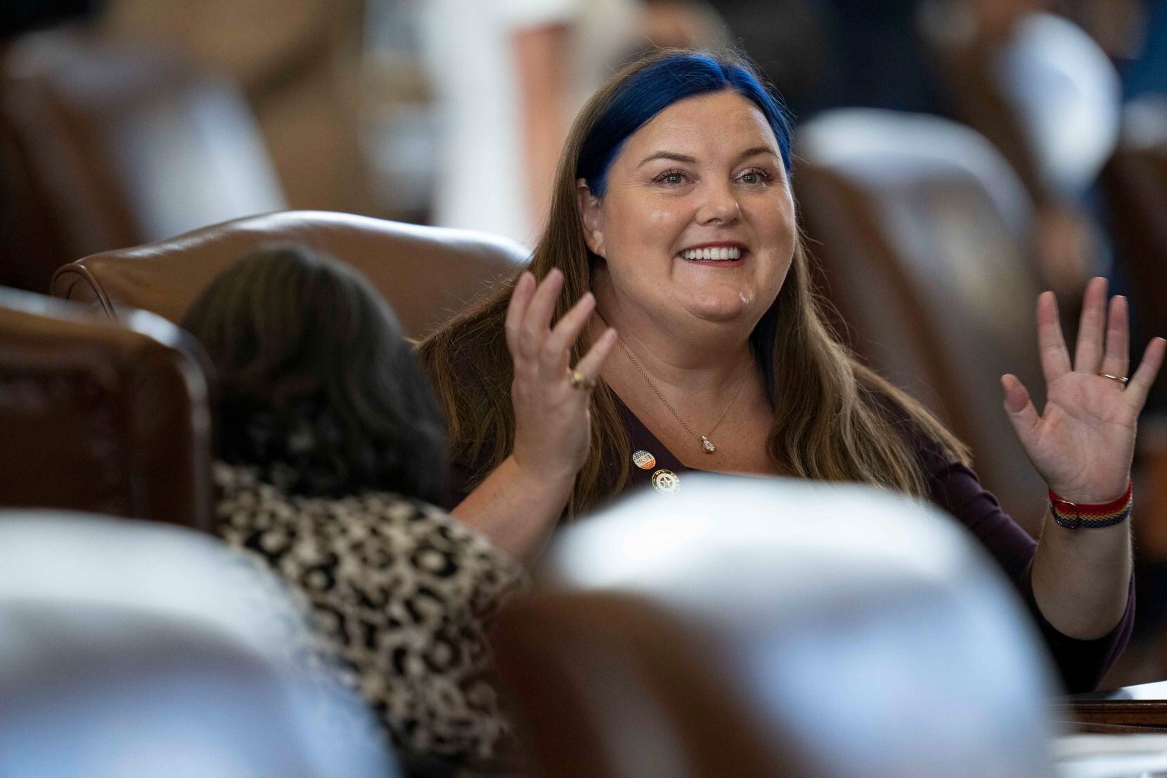 State Rep. Michelle Beckley, D-Carrollton, greets a colleage to start the special session on...