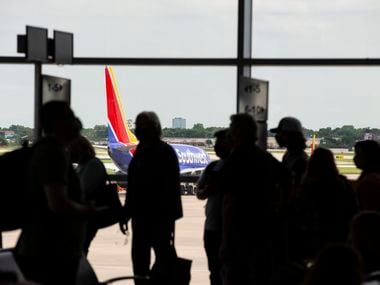 Passengers board a flight to New Orleans at Dallas Love Field in Dallas on May 19.