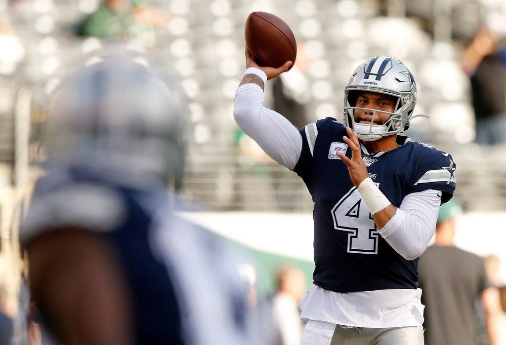 FILE - Cowboys quarterback Dak Prescott (4) warms up before a game against the New York Jets at MetLife Stadium in East Rutherford, N.J., on Sunday, Oct. 13, 2019.
