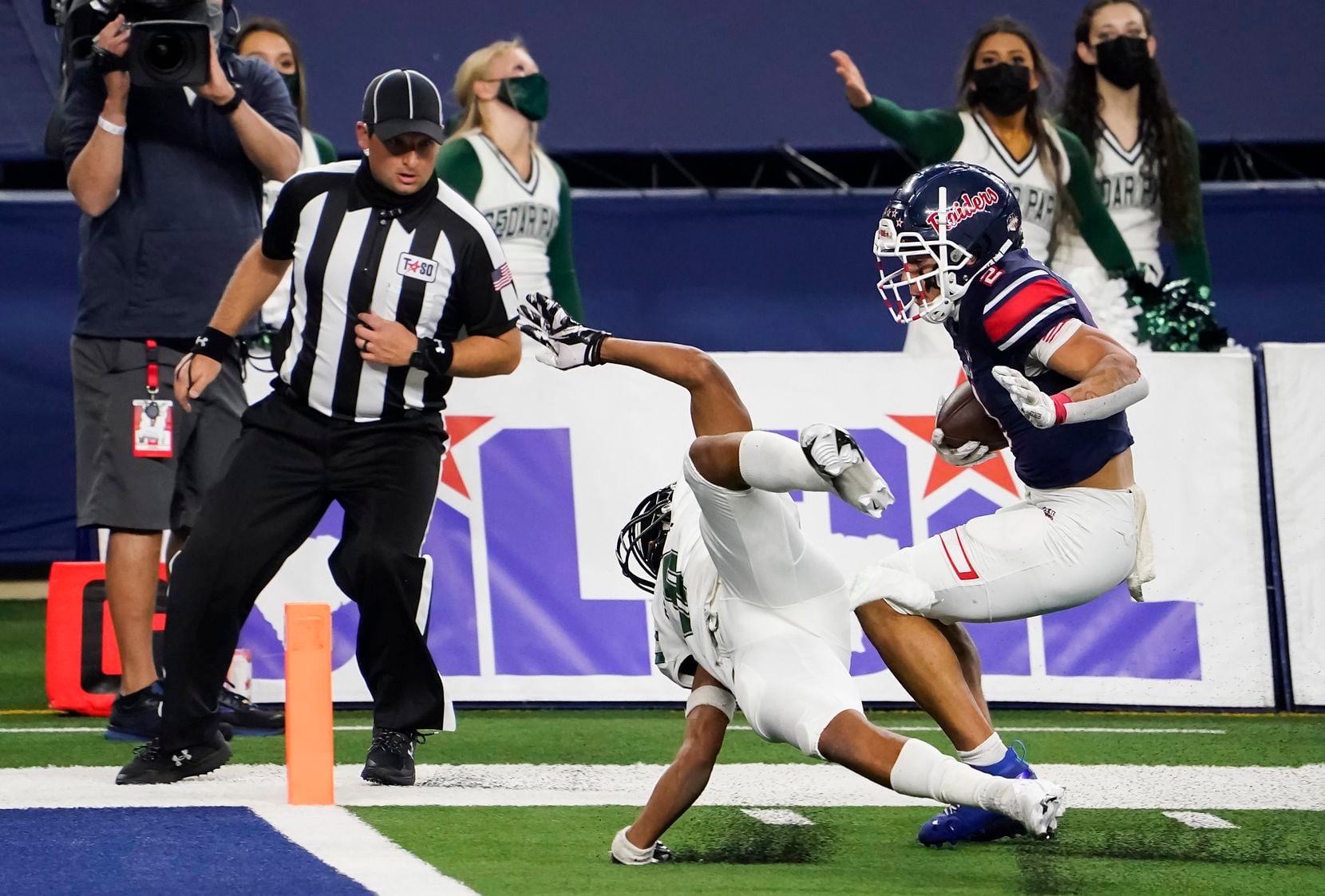 Denton Ryan Billy Bowman Jr. (2) slips past Cedar Park defensive back Michael Putney (6) to score on a hauls in a 37-yard touchdown pass from quarterback Seth Henigan during the first half of the Class 5A Division I state football championship game at AT&T Stadium on Friday, Jan. 15, 2021, in Arlington, Texas. (Smiley N. Pool/The Dallas Morning News)