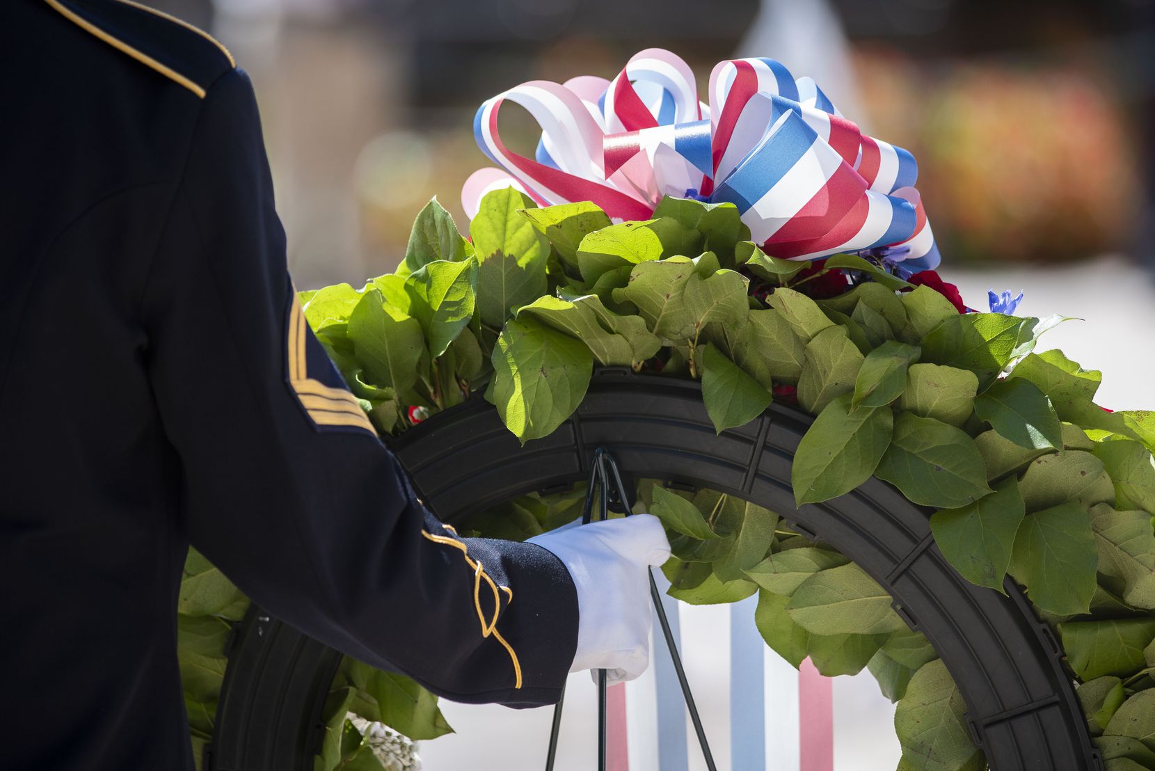 A member of the Army 3rd U.S. Infantry Regiment, The Old Guard, holds a wreath prior to it...