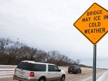 Cars drive across an icy bridge over Northwest Highway on Skillman Street in Dallas on...