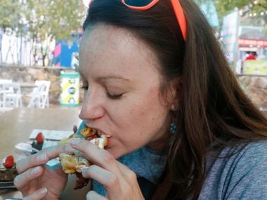 Tiney Ricciardi of the Dallas Morning News GuideLive team samples the Funnel Cake Bacon...
