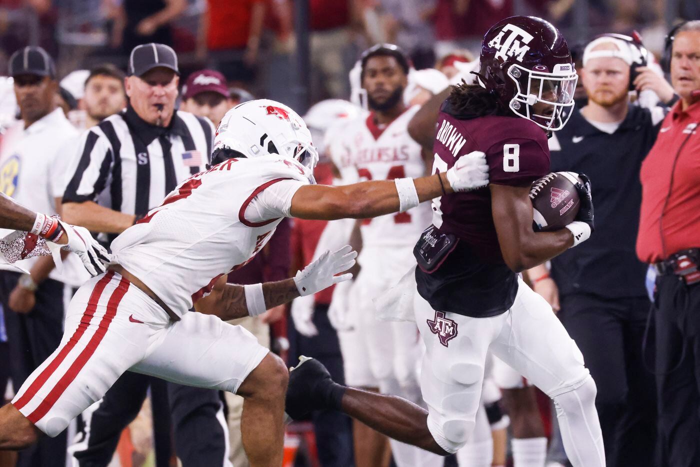 Texas A&M wide receiver Yulkeith Brown (8) gets pulled by  Arkansas defensive back Myles...