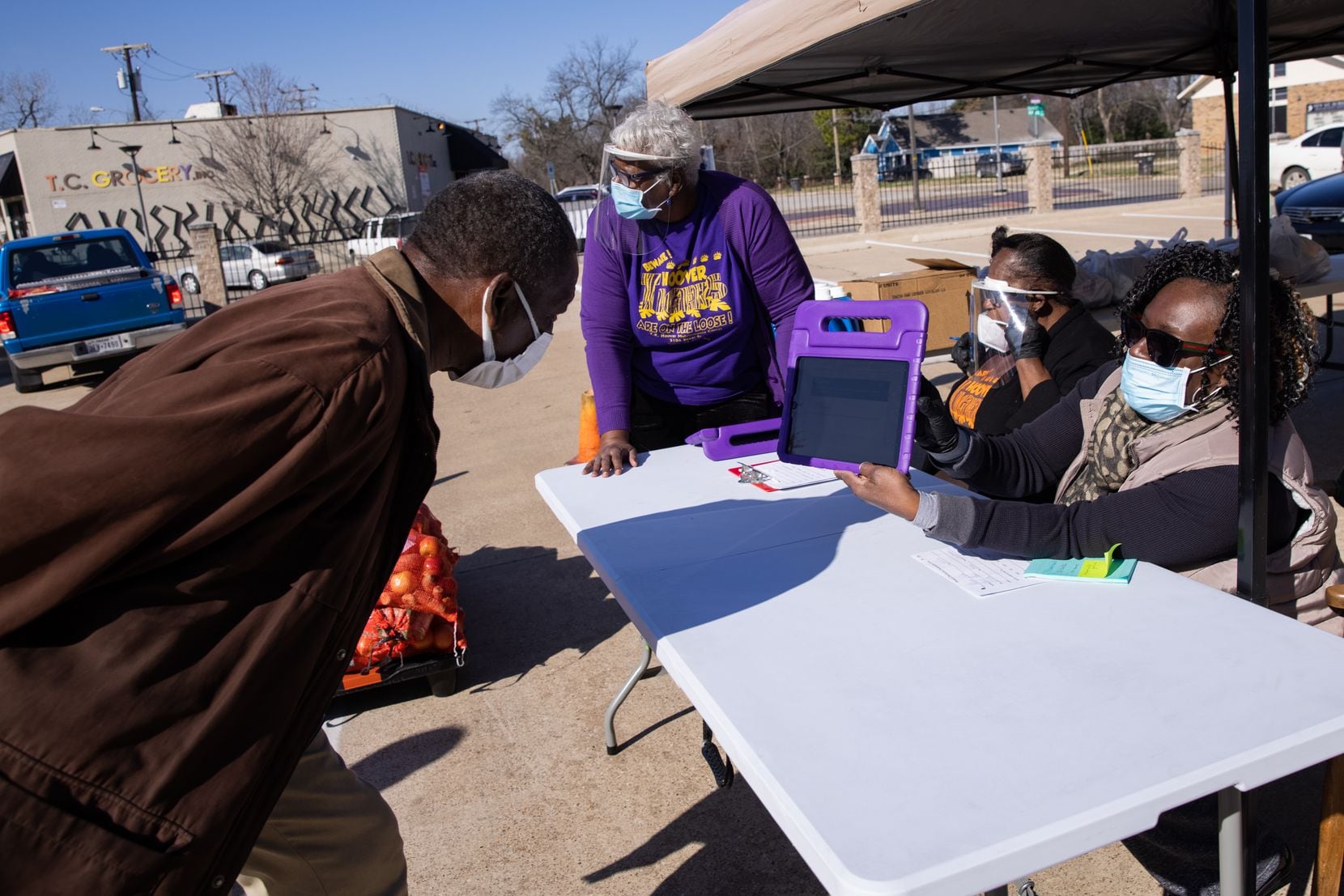 George Allen, 66, is registered for the vaccine by Frenchell White after walking up to T.R. Hoover community center in Dallas on Tuesday, Jan. 26, 2021. Allen said this made the registration easier. "I wanted to register but it was just too complicated," Allen said. (Juan Figueroa/ The Dallas Morning News)