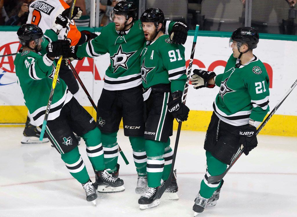 Dallas Stars center Jason Dickinson, second from left, celebrates his goal with teammates...