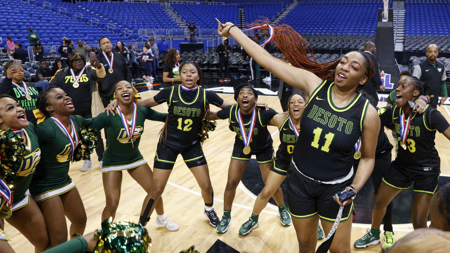 DeSoto forward Tionna Herron (11) dances with her team after winning the Class 6A state...