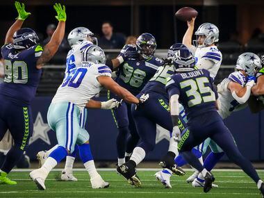 Dallas Cowboys quarterback Cooper Rush (10) gets off a pass under pressure from the Seattle...