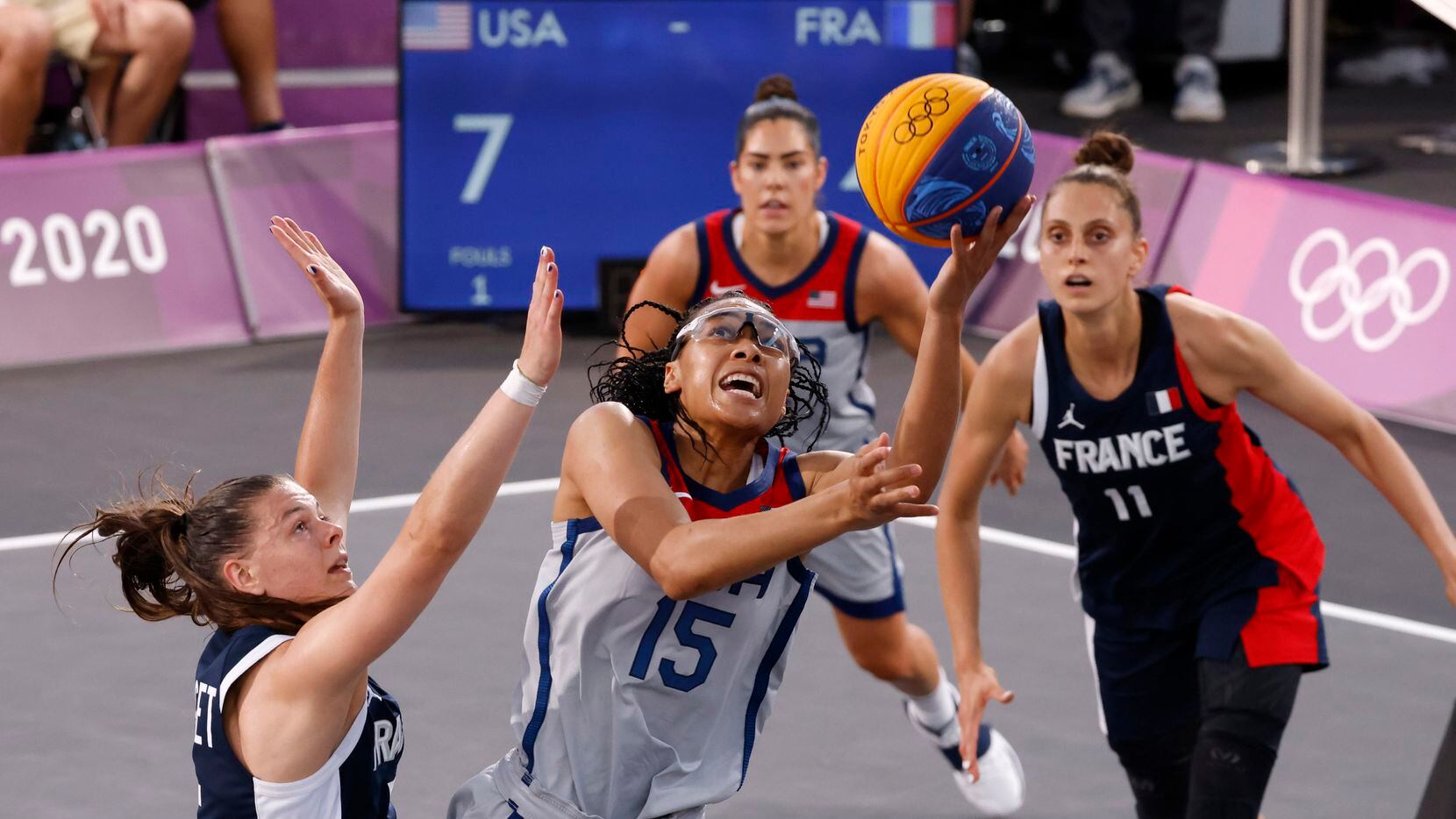 USA’s Allisha Gray (15) attempts a shot in front of France’s Marie-Eve Paget (5) during a...