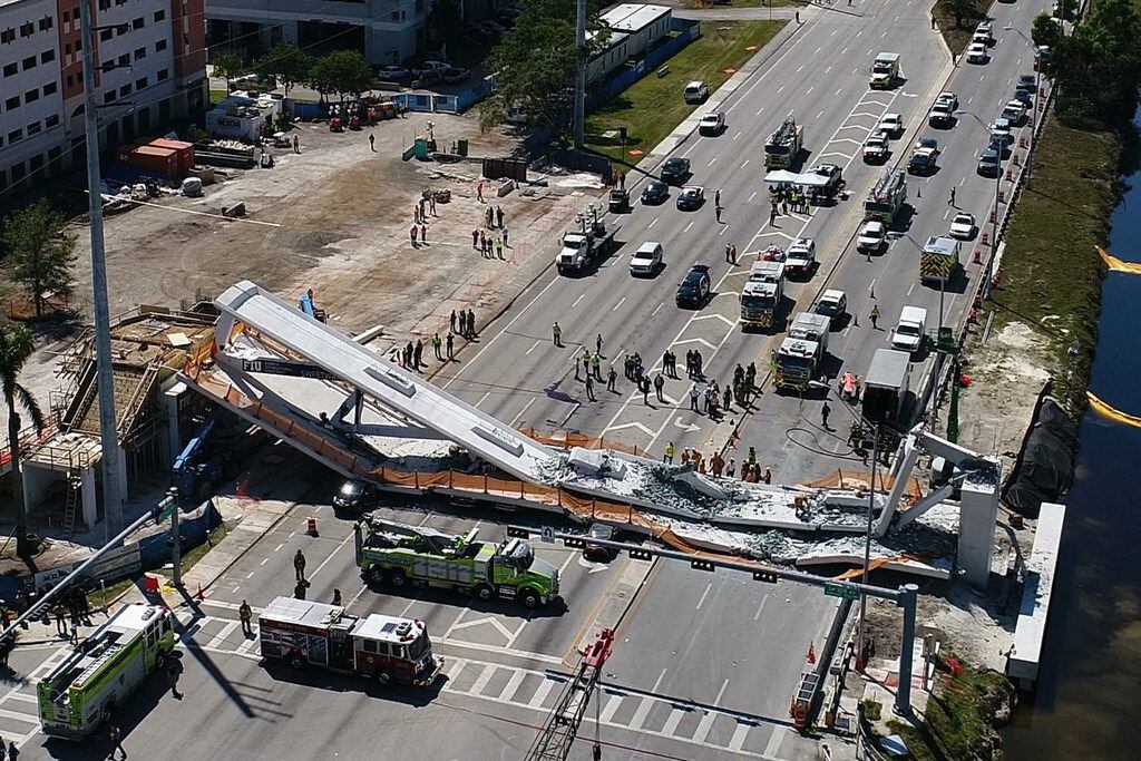 This photo provided by DroneBase shows the collapsed pedestrian bridge at Florida...