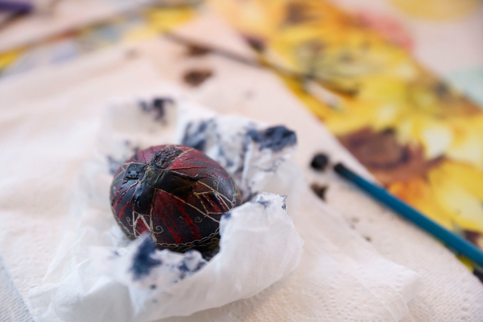 Lviv, Ukraine. 06th Apr, 2023. A young woman makes Easter eggs. A young  woman in traditional Ukrainian clothing makes Easter eggs using ancient  technology. Pysanka is an ancient tradition, one of the