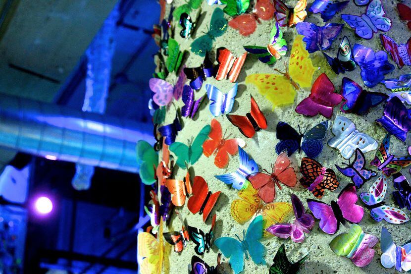 Thousands of soda-can butterflies adorn the tops of columns in the gallery level of SPARK!...