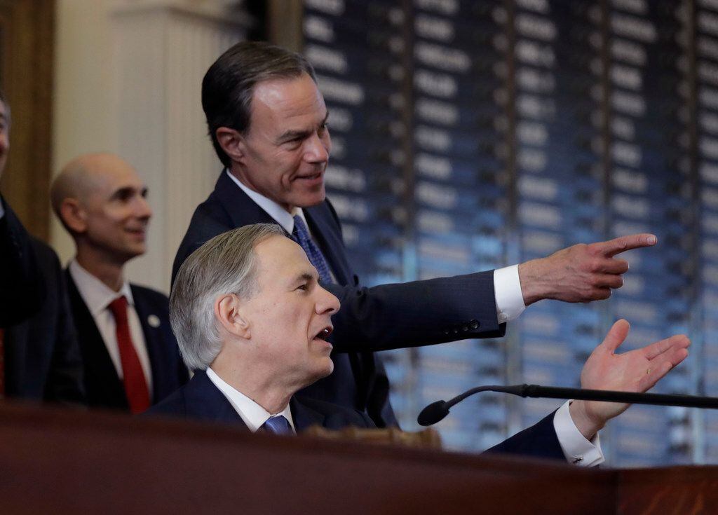 Texas Gov. Greg Abbott, front, and Texas Speaker of the House Joe Straus, R-San Antonio,...