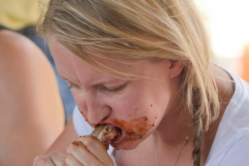 Lexie Denman participates in Riscky's Rib Eating Contest at the National Day of the American...