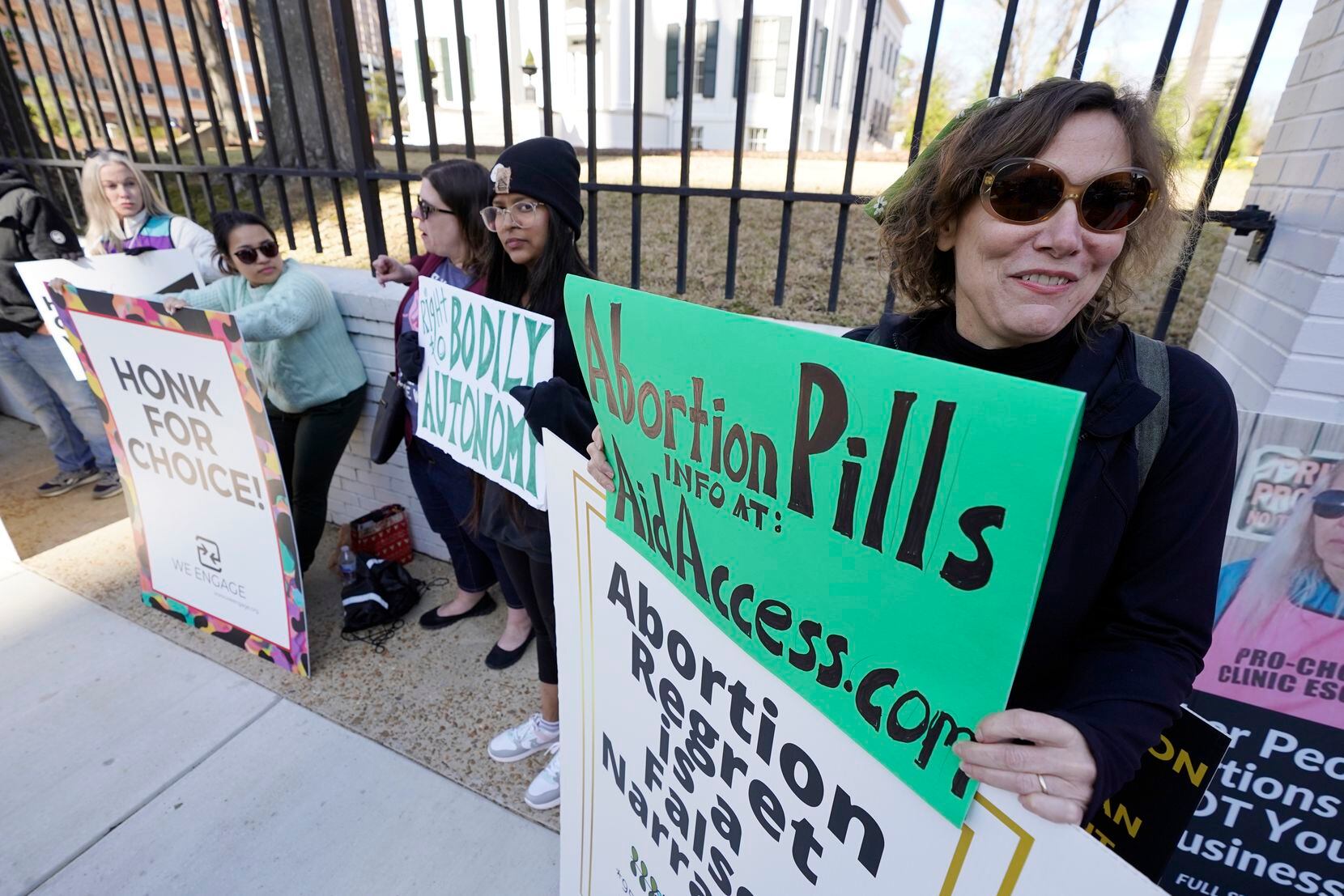 Heidi Barnett, a former Jackson abortion clinic escort, right, stands with a small group of...