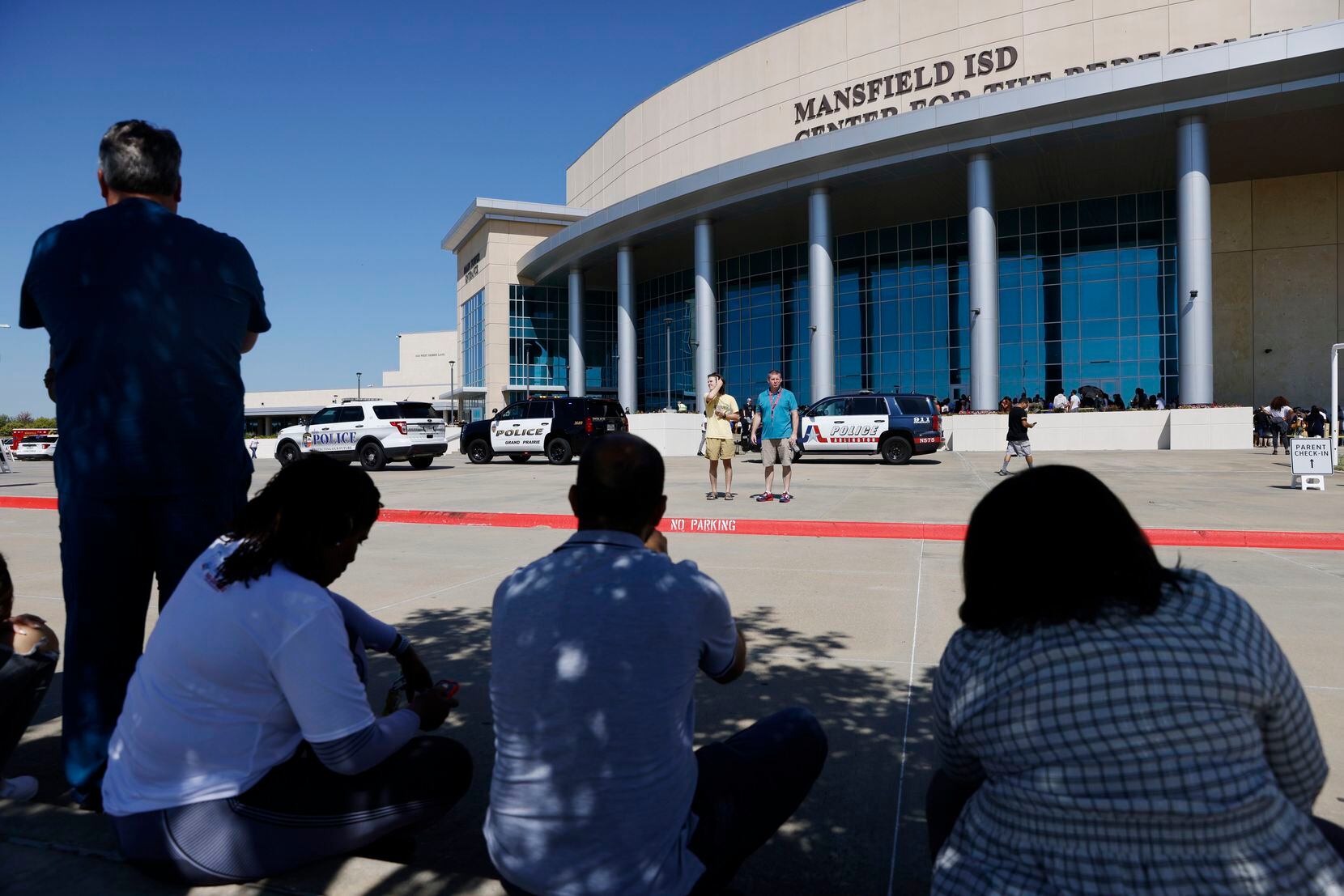 Parents of Timberview High School students wait outside of the Mansfield ISD Center for The Performing Arts on Wednesday, October 6, 2021 in Mansfield, TX.Four people were injured in a shooting at Timberview High School in Arlington on Wednesday morning, and authorities said the suspect remained at large.  (Elias Valverde II/The Dallas Morning News)