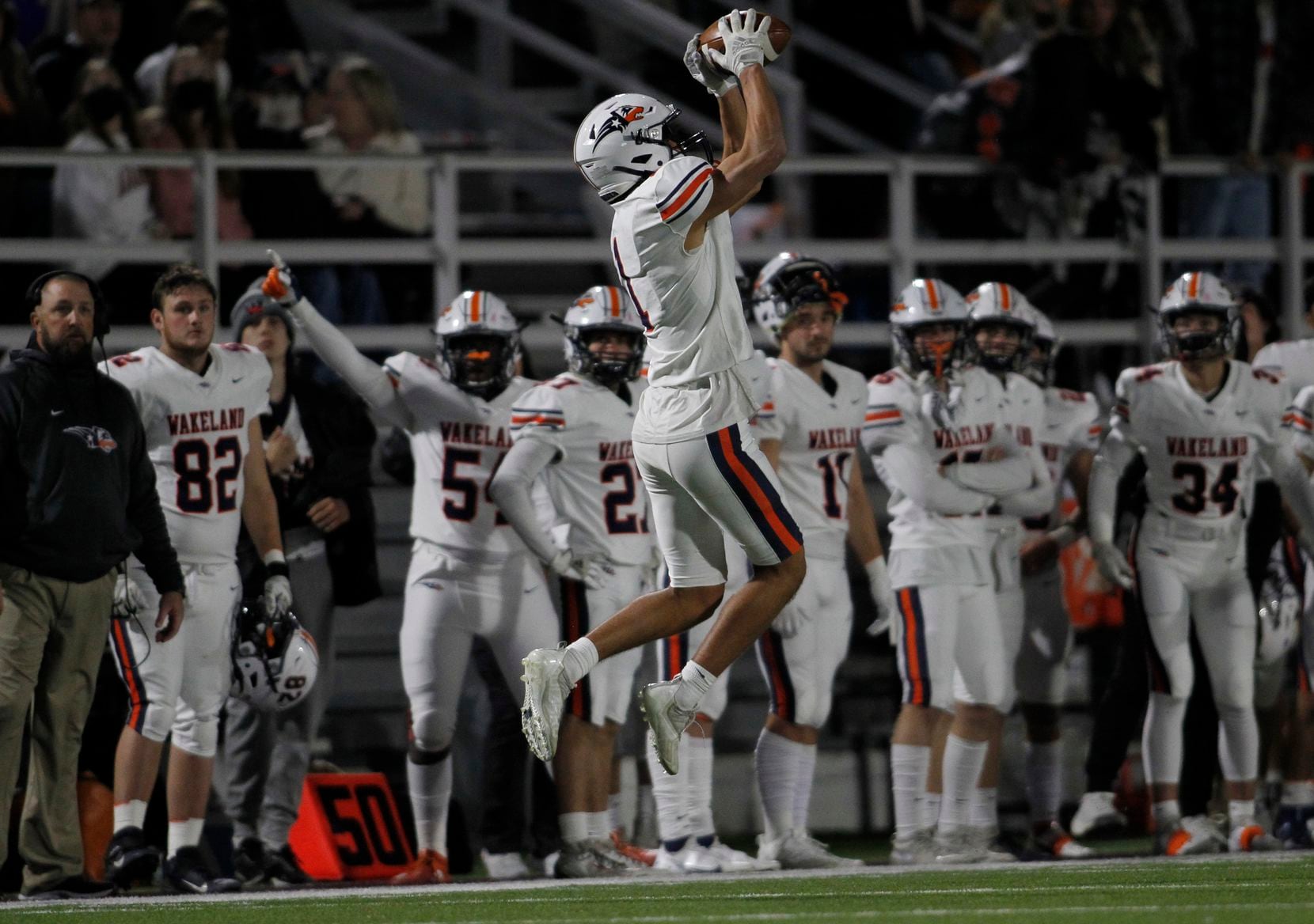 Frisco Wakeland receiver Davion Woolen (1) skies in front of the Wolverines bench to pull in...
