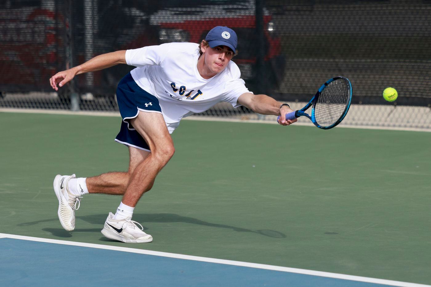 Highland Park’s Ray Saalfield stretches for a shot during the 5A boys doubles championship...