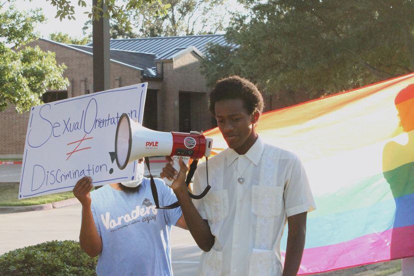 Devin Bryant stands in protest outside of Covenant Christian Academy in Colleyville on Aug....