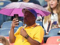 A fan watches the Dallas Cowboys and Denver Broncos during the second half of an NFL...