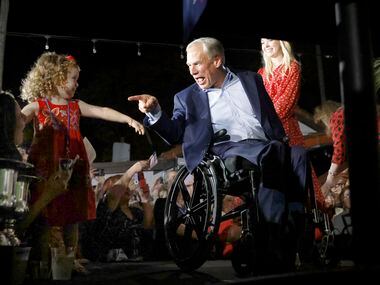 Texas Governor Greg Abbott points to young supporter in the front row as he arrives to make...