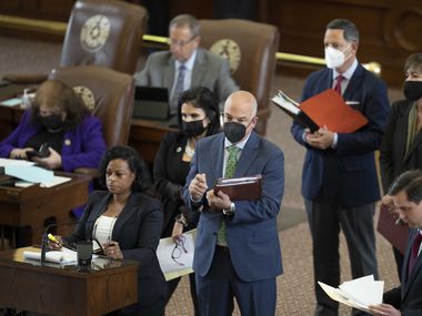 State Rep. NICOLE COLLIER, D-Fort Worth, speaks at the back mic while other representatives wait as the Texas House considers HB1, a redistricting bill, during a special session of the 87th Legislature.