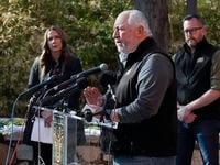 Gregg Hudson, center, president and CEO of Dallas Zoo Management, Inc., responds to...