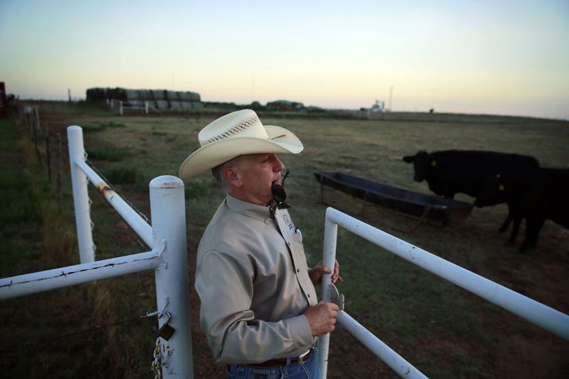 West Texas A&M Agriculture and Natural Sciences Acting Dean Dean Hawkins closes a gate on...