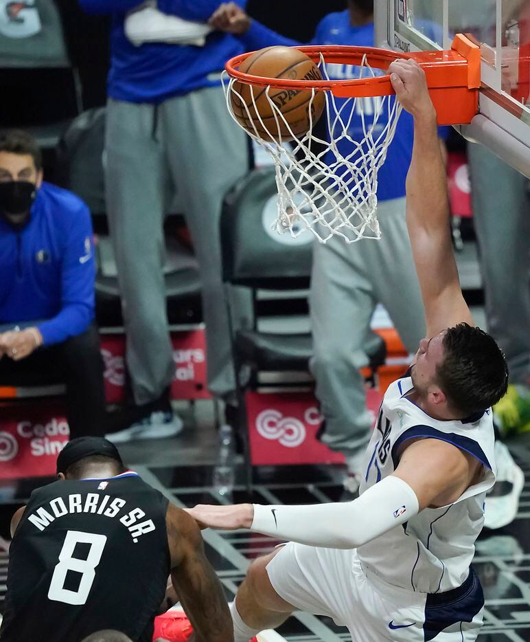 Dallas Mavericks guard Luka Doncic (77) dunks the ball past LA Clippers forward Marcus Morris Sr. (8) during the first half of an NBA playoff basketball game at Staples Center on Tuesday, May 25, 2021, in Los Angeles.