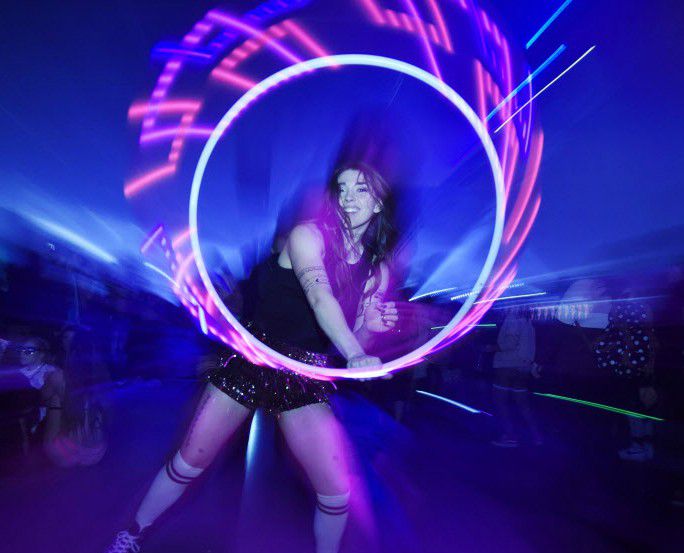 Taylor Scott of Frisco dances with her lighted hula hoop during Lights All Night electronic...