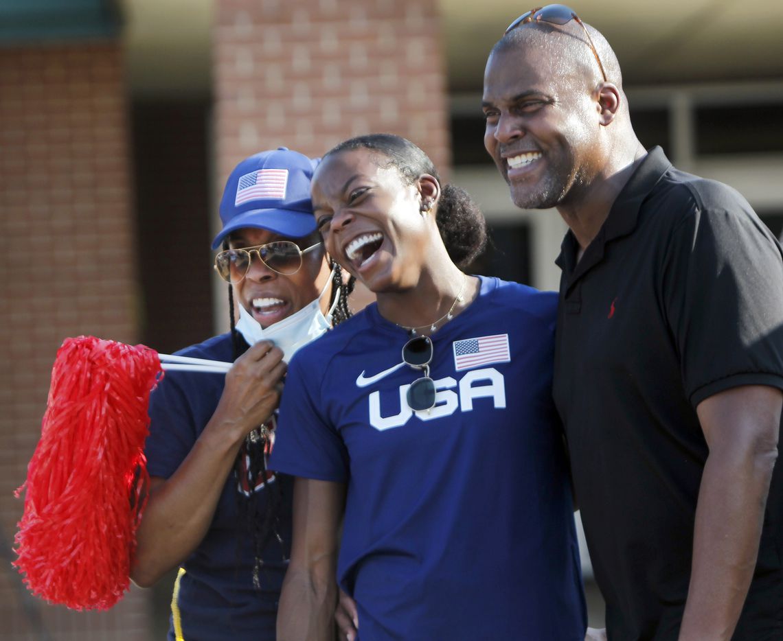 Jasmine Moore poses for a family photo with her two biggest cheerleaders, her parents Earl and Trinette Moore during a send off party as the Mansfield track star prepares to depart to compete in the Tokyo Olympics. The Olympic Send-Off for the Mansfield Lake Ridge graduate was held at Danny Jones Middle School in Mansfield on July 21, 2021. (Steve Hamm/ Special Contributor)