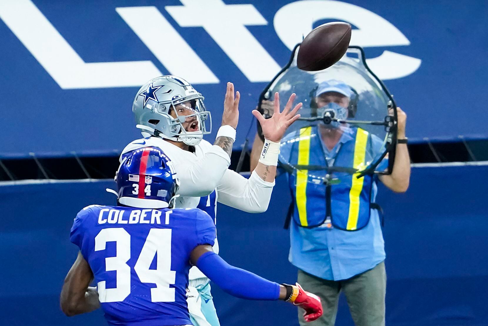 Dallas Cowboys quarterback Dak Prescott (4) catches a touchdown pass from wide receiver Ced Wilson past New York Giants safety Adrian Colbert (34) during the second quarter of an NFL football game at AT&T Stadium on Sunday, Oct. 11, 2020, in Arlington. (Smiley N. Pool/The Dallas Morning News)