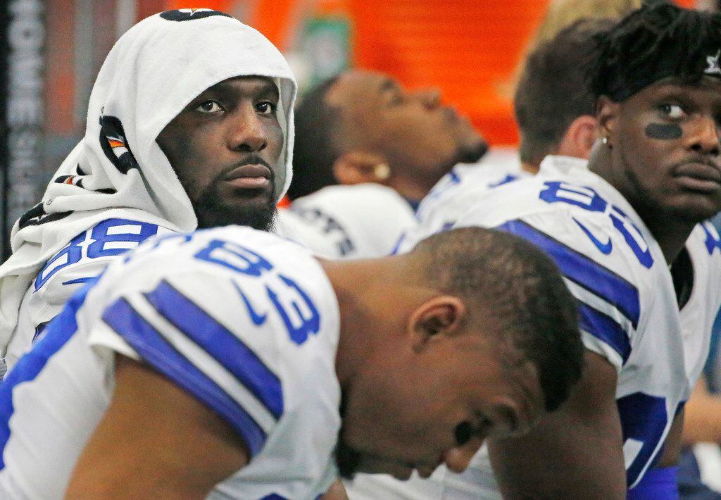 FILE - Dez Bryant (88, left) is pictured with teammates on the bench during the fourth...